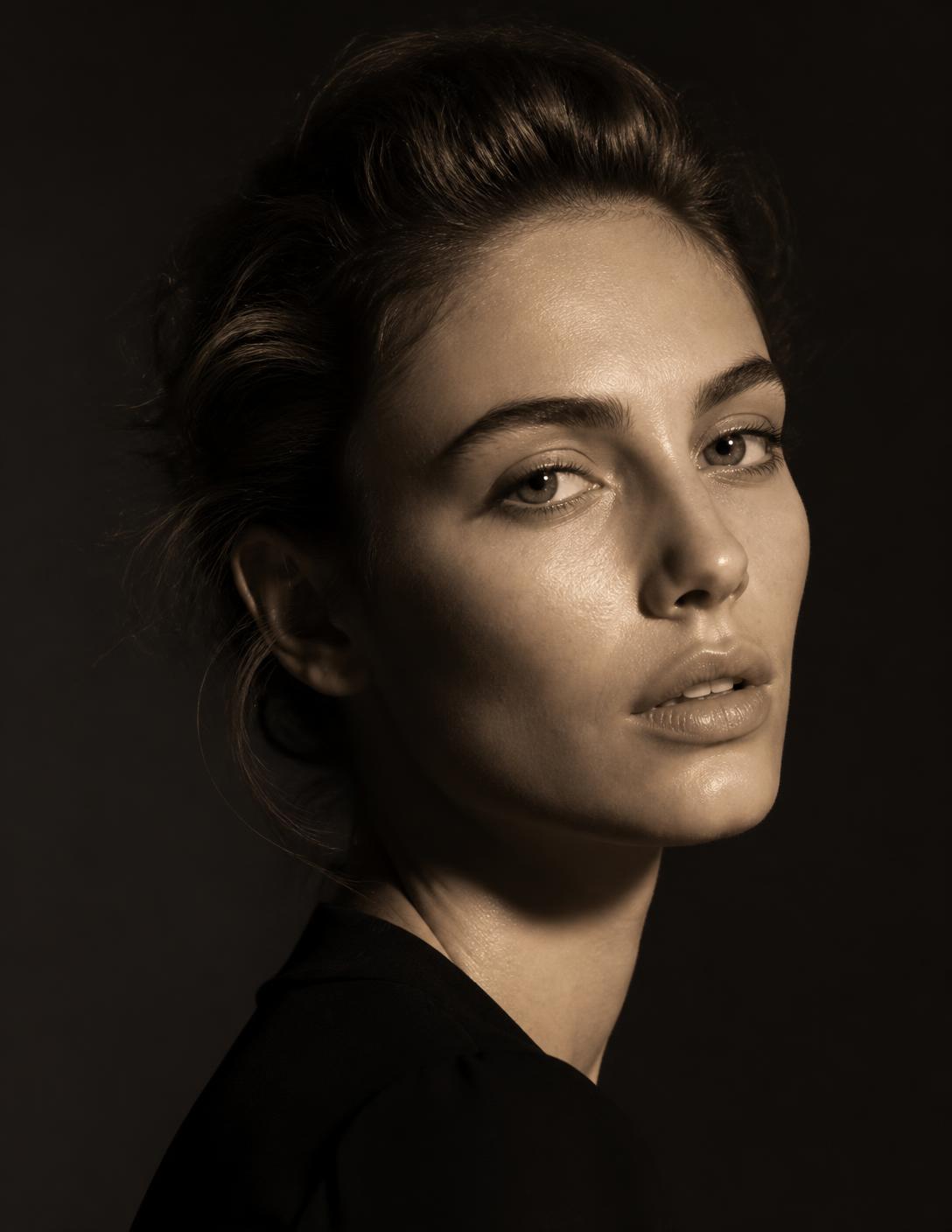 Luxe Management model photographed under a single warm studio light